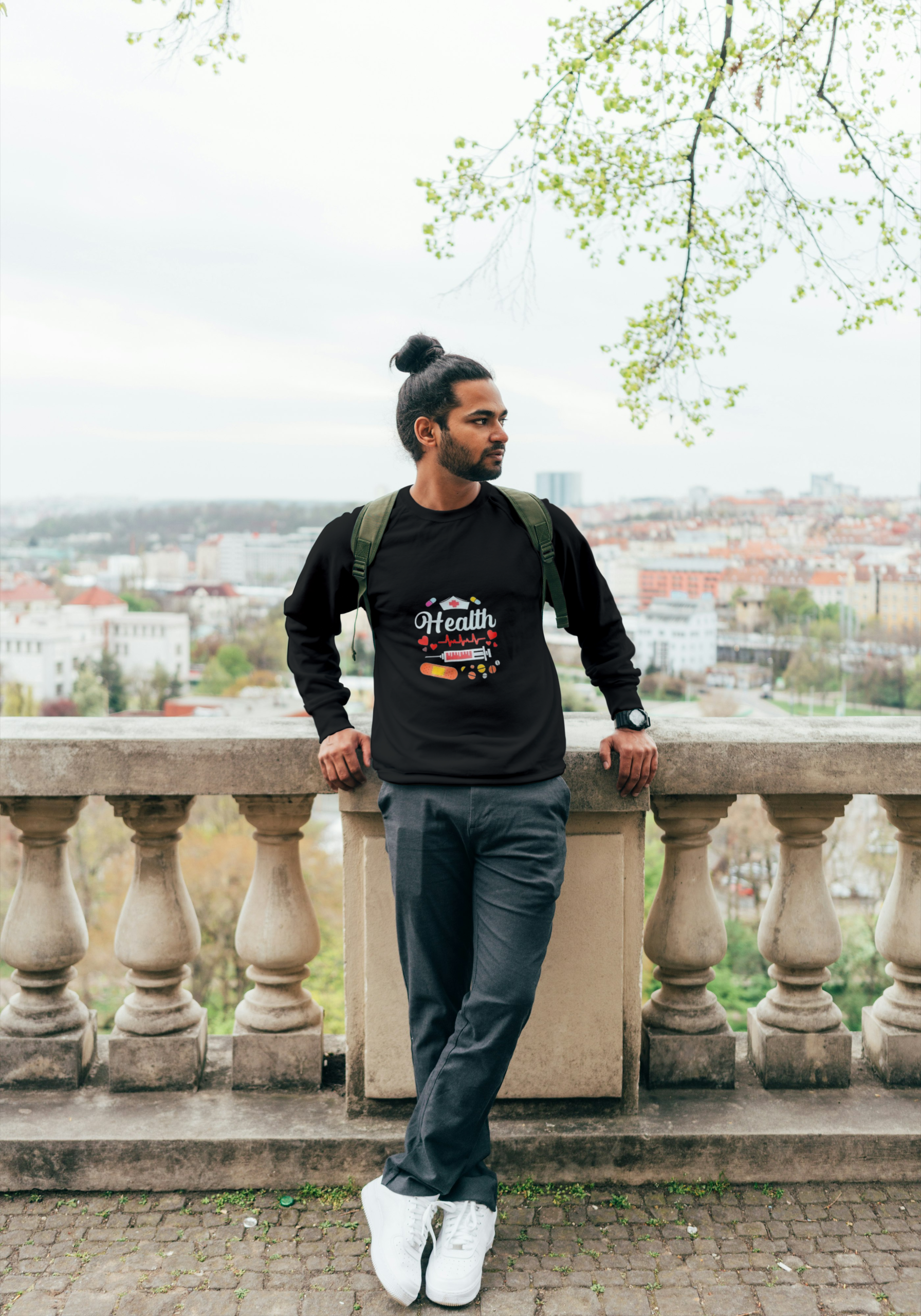 Man wearing a black unisex sweater with a classic fit, styled for comfort and everyday wear.