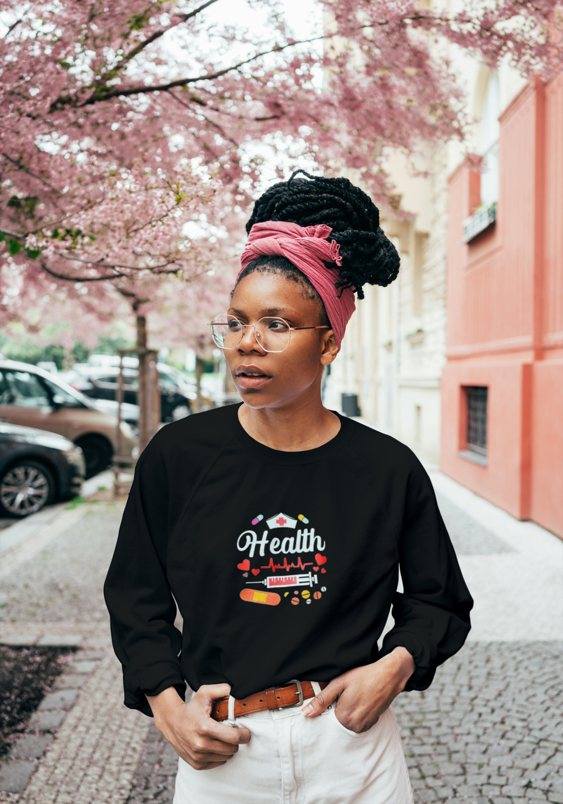 Woman wearing a black unisex sweater with a classic fit, designed for comfort and casual style.